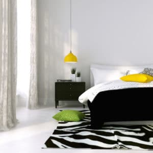 Black and white bed and a yellow lamp