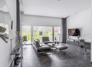 Big window in trendy grey living room interior of suburban house