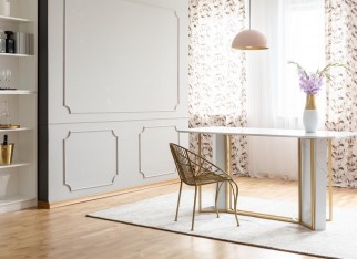 Real photo of a glamour dining room interior with a table, chair, flower and empty wall. Place your painting